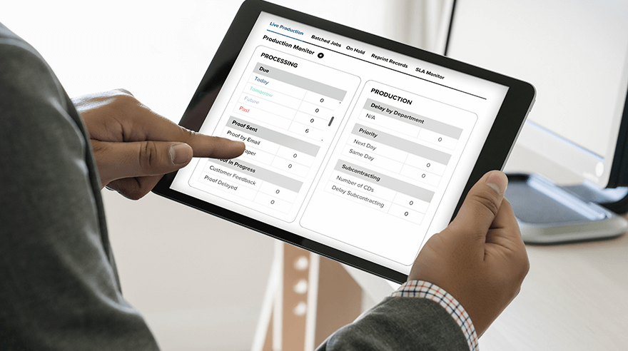 Man reviewing triggered mailers on a tablet