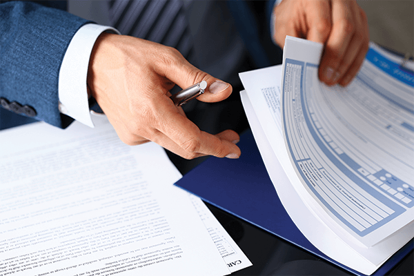 Man flipping through documents