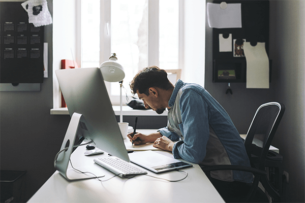 Man designing a postcard