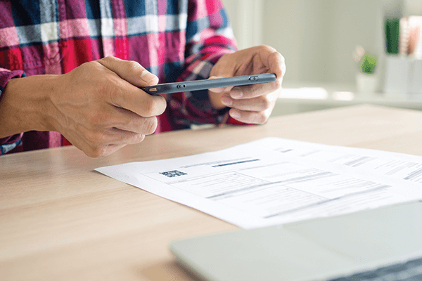 Person Scanning QR code on Paper